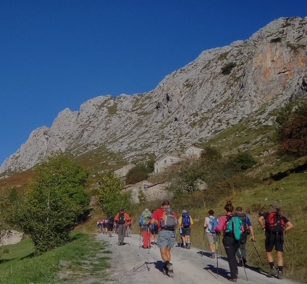 gruppe von pilgern auf einem wanderweg durch berge und wiesen entlang des camino del norte